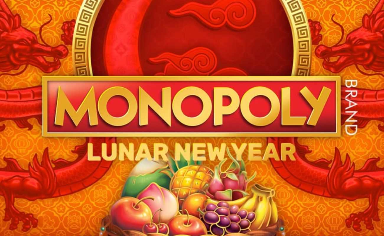 The title screen for the Monopoly: Lunar New Year slot game, featuring the game’s logo and an illustration of a fruit basket on an orange background decorated with detailed, Oriental-style patterns and two red dragons.