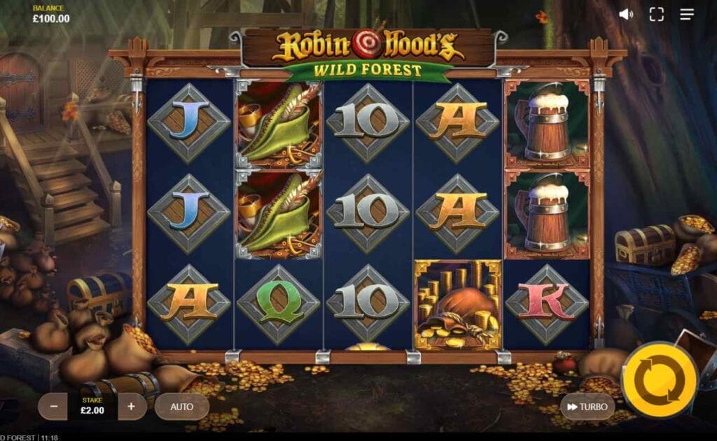 Robin Hood’s Wild Forest online slot with playing cards symbols against a silver diamond frame, beer jugs, and green feather hats on the reels. The background space contains treasure chests and sacks of gold.