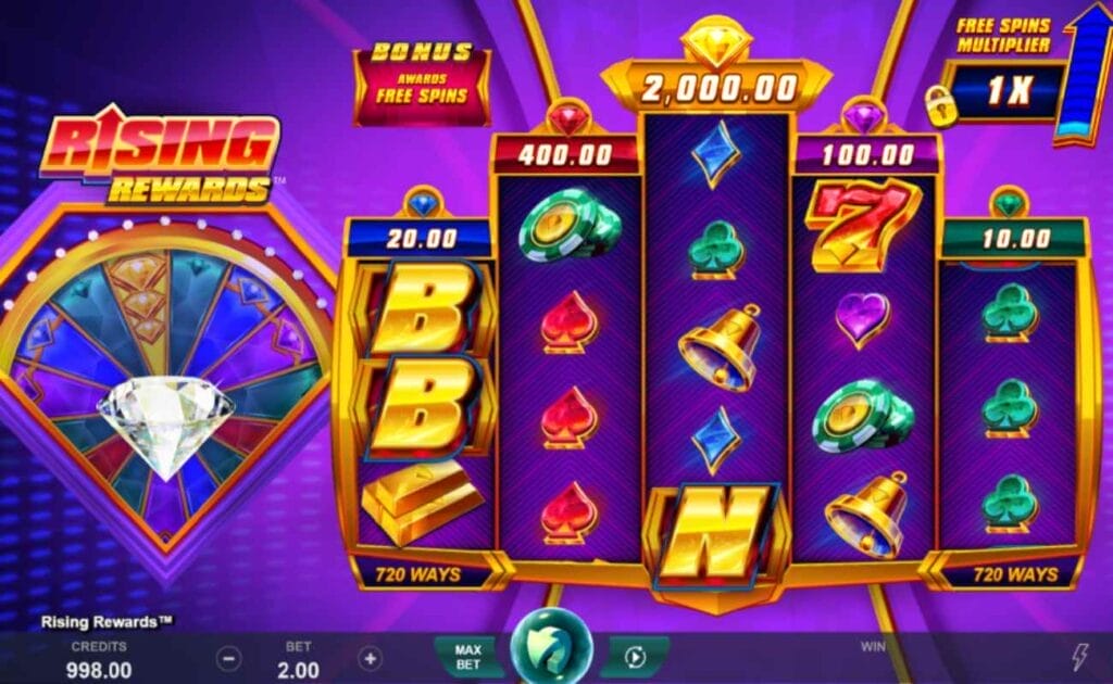 Rising Rewards online slot with gold reel frames and a dark purple background. The reels contain a gold bell and playing card suits (clubs, diamonds, hearts, and spades). The game screen is purple with gold elements.