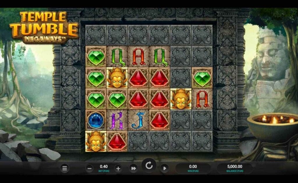 A screenshot of the reels in Temple Tumble Megaways. The game is set among the ruins of an ancient civilization with a wild jungle in the background. The reels contain a variety of symbols, including ancient deity masks, different colored gems, and standard playing card symbols, including A, K, Q, and J. 