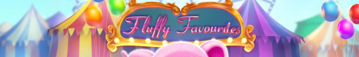 A screenshot of the Slingo Fluffy Favorites title screen. The game’s title is displayed in a cute font on an intricately detailed frame with lights. This frame sits in front of the tents at a carnival, and balloons surround the carnival setting.