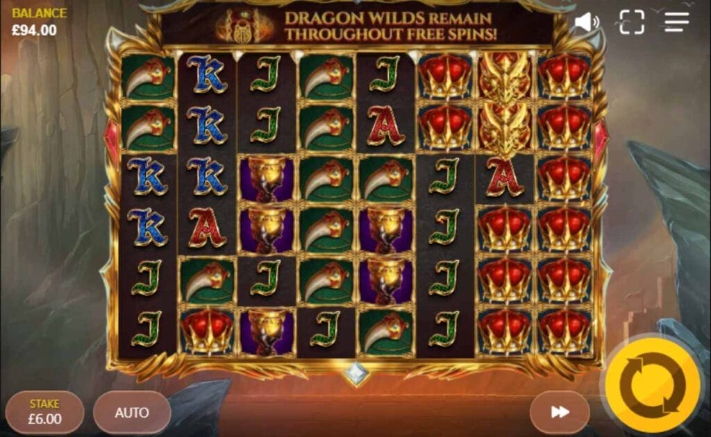 Reel Keeper Power Reels online slot with a crown, gold-encrusted canine tooth and playing card symbols on the reels. The background shows an ancient city with a huge mountain.