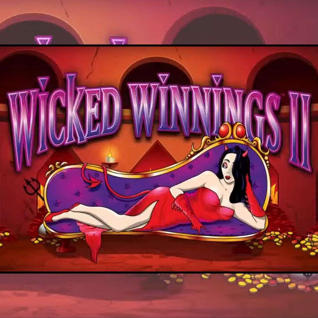 The title screen for Wicked Winnings II, featuring the game’s beautiful devil character lying down on a purple sofa and resting her head on her hand with piles of gold coins around the room.
