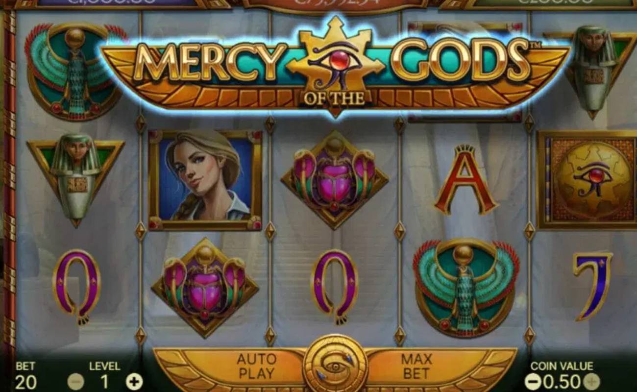 A screenshot of the reels in Mercy of the Gods. The game is set against the inside of a rich Egyptian pyramid. The reels contain symbols such as the game’s female protagonist, a bird raising its wings to the sun, an illustration of an Egyptian eye, a scarab, and an Egyptian emperor. Other symbols include the A, Q, and J.