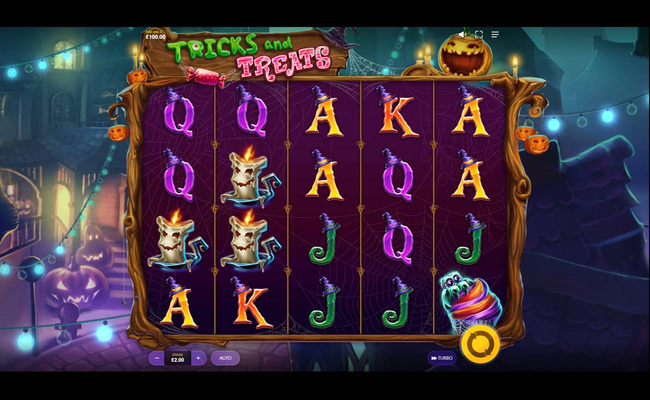 A screenshot of Tricks and Treats. The game is set in a spooky Halloween-themed town filled with glowing blue lights, jack-o’-lanterns, and creepy shadows. The reels are equally spooky and filled with symbols like melting candles with faces, a spider hiding behind a cupcake, and A, K, Q, and J slot symbols.