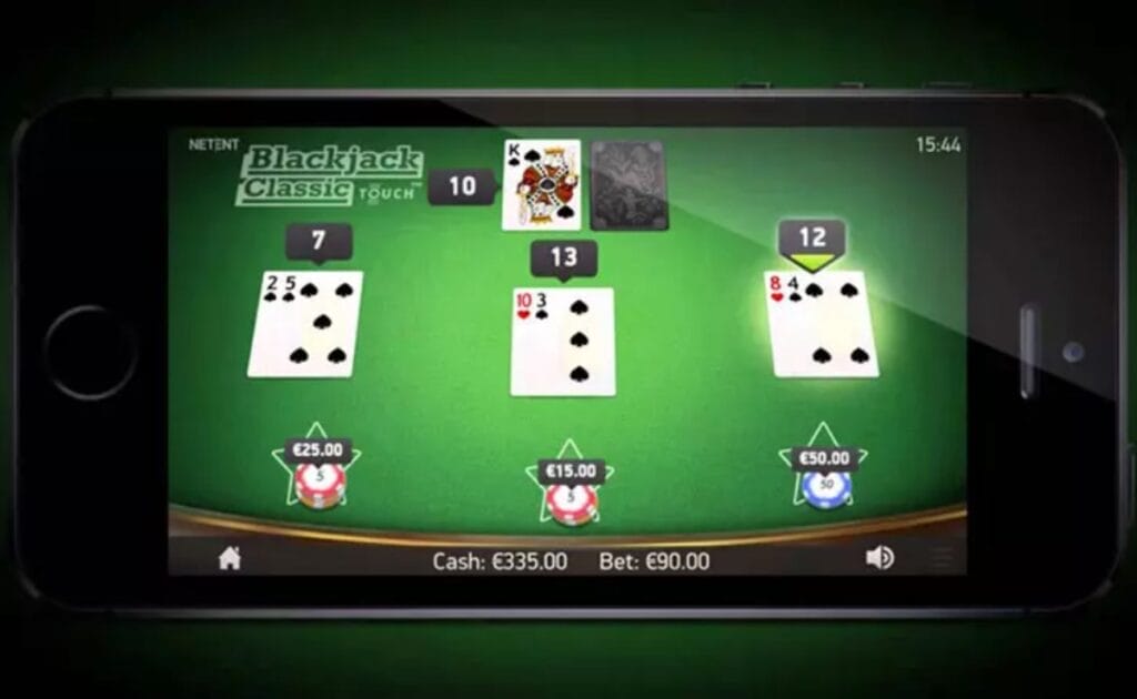 Blackjack Classic Touch online casino game on a smartphone screen. The casino table is green with playing cards and casino chips.