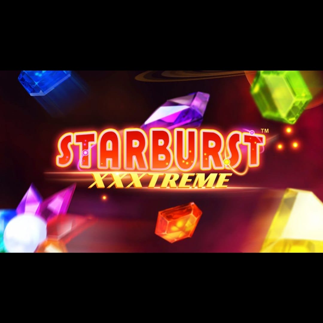 Starburst XXXtreme online slot game with green, purple, blue, and yellow gemstones. The logo is gold and red. The background is red and resembles outer space.