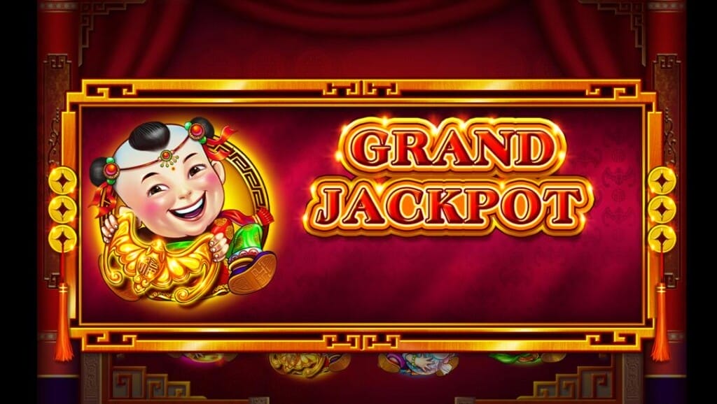 A screenshot of a Grand jackpot win in 88 Fortunes. In the background are draped red curtains hanging over various partially visible symbols. In the foreground is a detailed gold and red frame with an image of one of the game’s mascots and the words “Grand Jackpot” inside it. Red strings with three gold coins hang on either side of the Grand Jackpot notice.