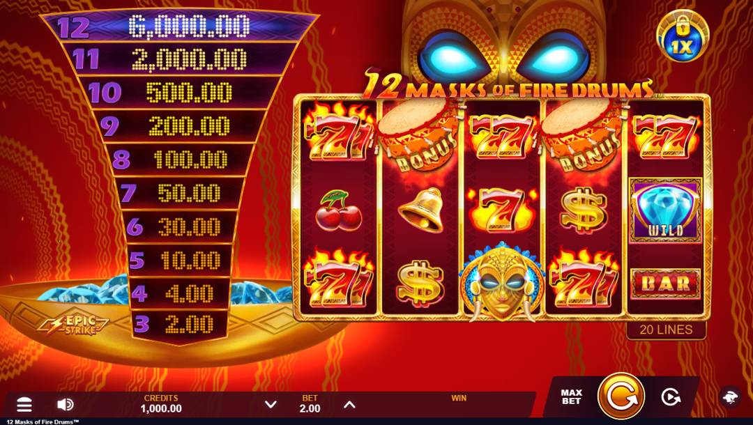A screenshot of the slot reels in 12 Masks of Fire Drums. The background is a red fabric with gold designs that have a circular shape, giving the space a cylindrical appearance. In the foreground are the gold and red slot reels. These reels feature many themed symbols, including fiery triple 7s, bonus scatter African drums, gold bells, dollar signs, Epic Strike gold African masks with blue trimming, BAR symbols, and blue diamond wilds on gold and purple plaques. Behind the reels is an ornate gold African mask with glowing blue eyes. To the left of the reels is the Epic Strike prize ladder with 10 prizes. Behind the prize ladder is a gold bowl with blue diamonds.