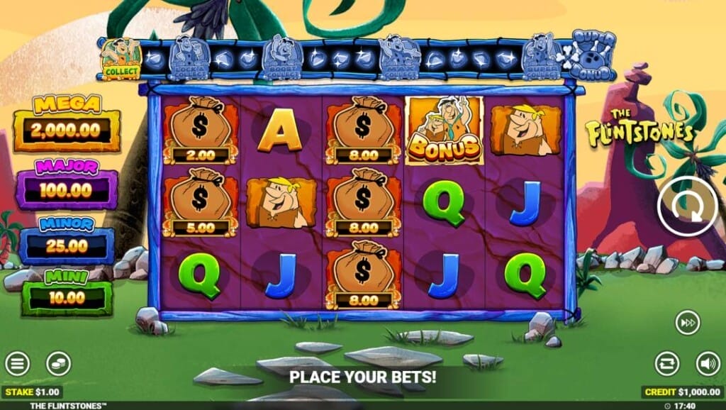 A screenshot of the slot reels in The Flintstones. The background is a grassy lawn in Bedrock. There are palm trees and rocky peaks below an orange sky. Sitting on the grass, in the foreground, are the game’s reels in a wooden border. The reels contain a variety of Flintstone-themed symbols, including Barney, Fred, and Barney bonus, and money bag symbols. There are also regular symbols, such as the A, Q, and J. On the left of the reels are the four jackpot prizes. Above the reels is the game’s bonus meter. On the right of the reels is the game’s main interface.