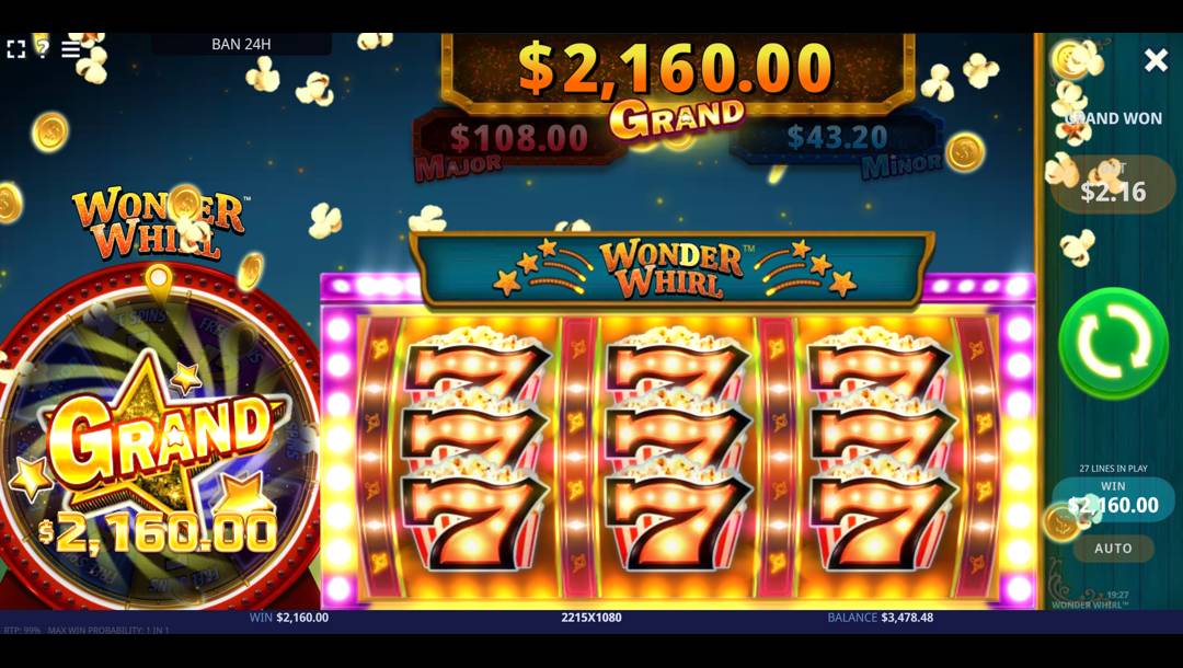 A screenshot of a Grand jackpot win in the Wonder Whirl online slot game. In the background, festive elements such as gold coins and popcorn fly through a starry blue night sky. The left side features a large red and gold prize wheel with the word “GRAND” across a shining golden star. Jackpot tiers are displayed at the top of the screen, with the Grand jackpot highlighted. In the foreground, the slot reels are completely filled with red 7s, all sparkling with golden popcorn toppers. Bright lights shine on and next to the reels.