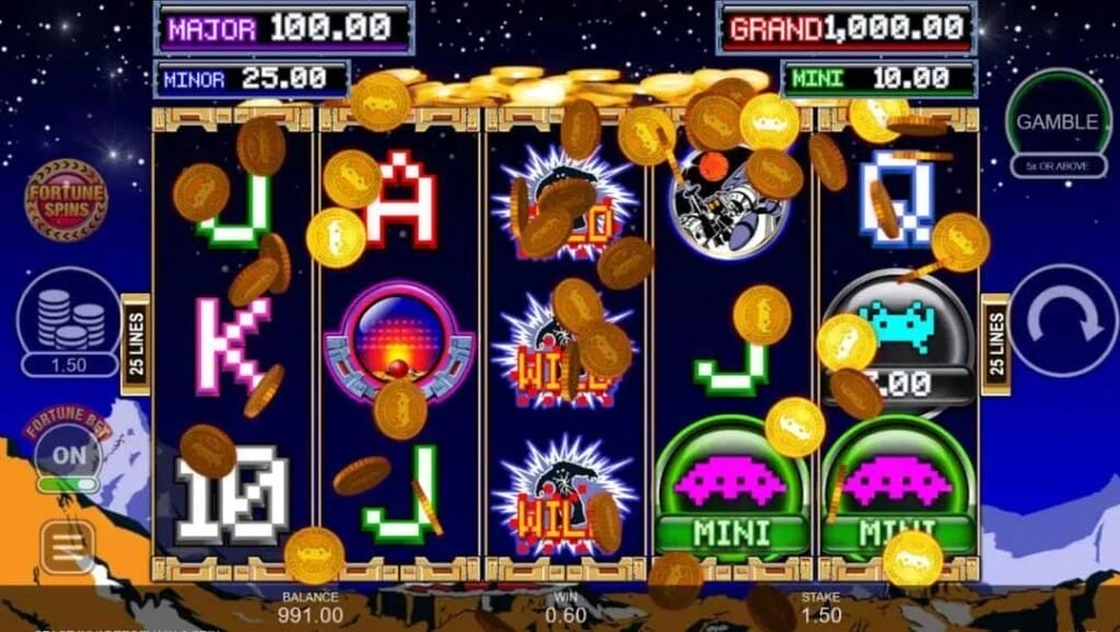 A screenshot of the Space Invaders Win and Spin slot. The background is an 8-bit style rendering of a mountain range with stars above it. In the foreground are the slot reels. Coins are falling in front of the reels which are filled with spaceship symbols, alien symbols, playing card symbols, and more.