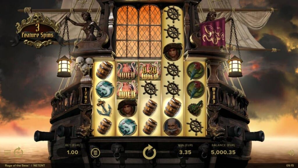 A screenshot of the Rage of the Seas slot game featuring a pirate ship-themed interface with five illuminated reels displayed in the center of a wooden galleon. Symbols on the reels include barrels, ship wheels, parrots, anchors, wild flamingos, and pirate portraits, with a small win. The background reveals a dusky seascape with dramatic clouds and sails. Above the reels, a golden sign reads “3 Feature Spins,” while the bottom displays the player's bet, current win, and balance. 