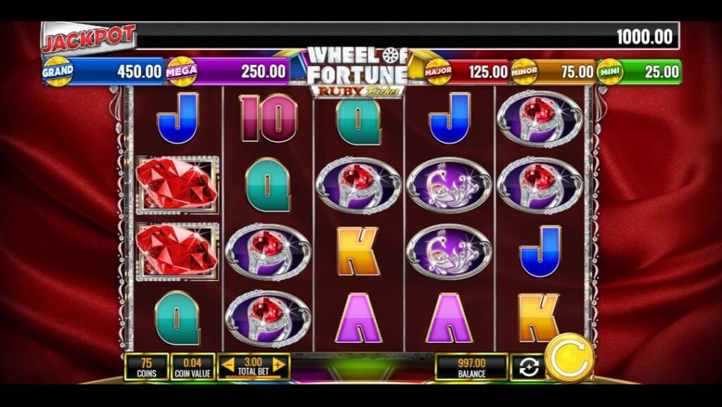 A screenshot of the slot reels for Wheel of Fortune Ruby Riches. The background is a piece of luxurious red fabric with deep, dark shadows. In the foreground are the slot reels with various ruby-themed jewellery and jewels, as well as playing card symbols.