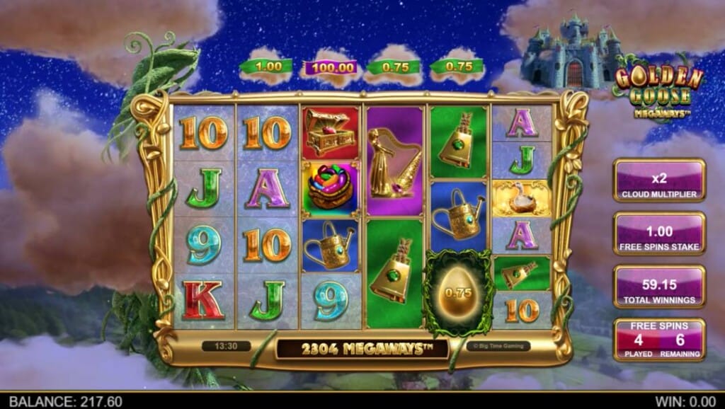 A screenshot of the slot reels in Golden Goose Megaways. The background is a view above fields and forests at night, with clouds surrounding the reels. The golden reels are filled with playing cards and themed slot symbols.