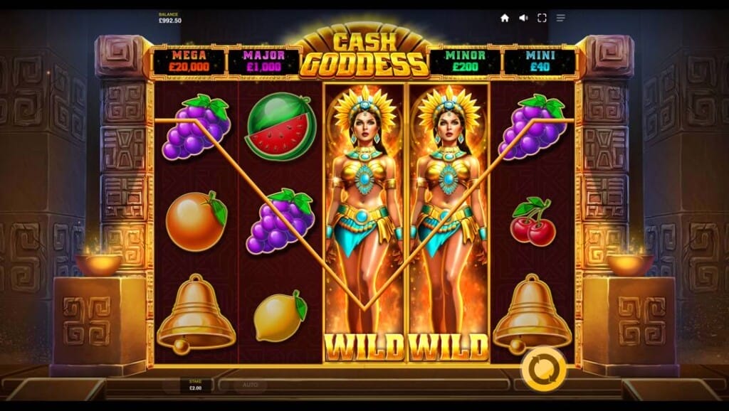 A screenshot of the Cash Goddess slot reels with a wild symbol win. The background is an ancient Aztec temple shrouded in darkness, except for the slot reels, which are bathed in golden light. 
