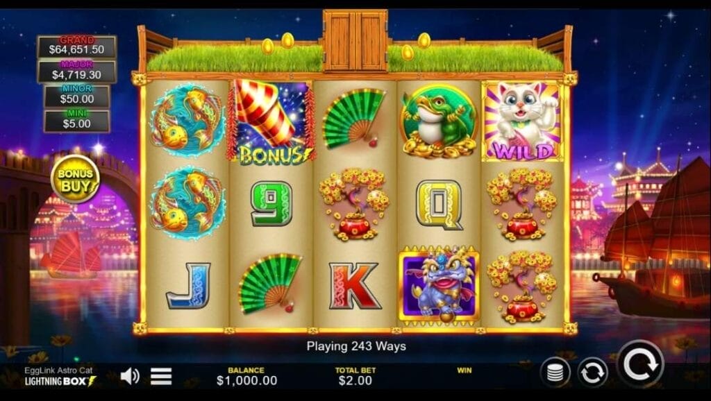 The EggLink Astro Cat Slot game interface showing five reels with 243 ways, featuring symbols including koi fish, firecracker bonus icon, green fan, frog, and a white cat wild symbol. Progressive jackpot values displayed on the left, with balance and bet amount shown at the bottom.