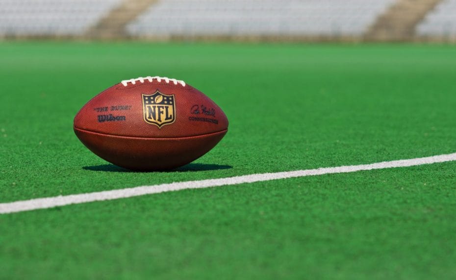 Official NFL football on a green football pitch