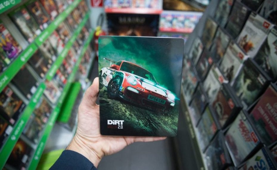 Man holding Dirt Rally 2.0 videogame on Sony Playstation 4 console in store