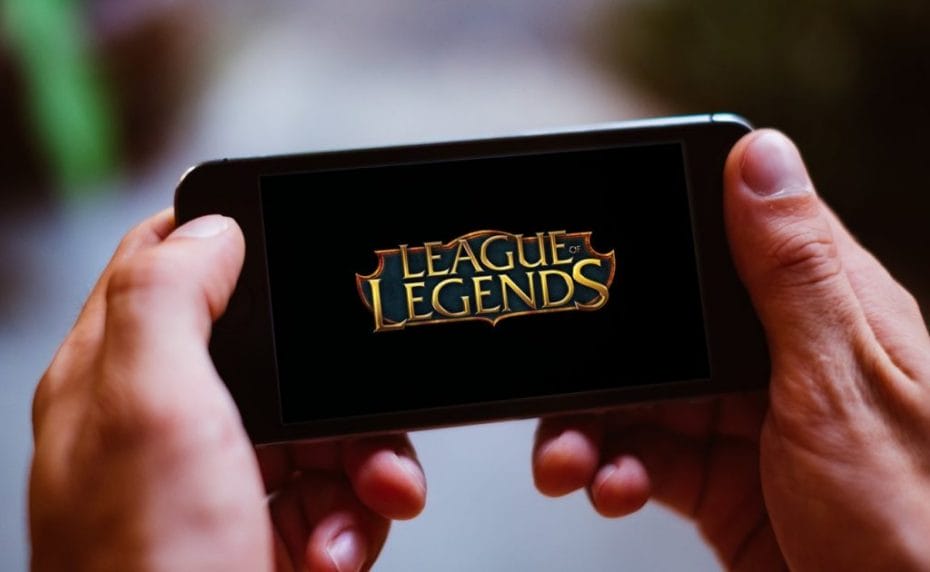 Closeup of smartphone screen with LEAGUE OF LEGENDS game logo