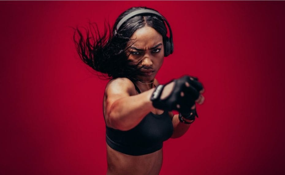 female boxer practicing boxing against a red background