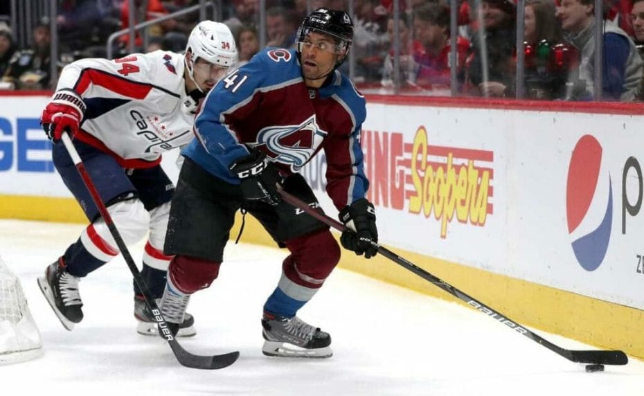Pierre-Edouard Bellemare #41 of the Colorado Avalanche brings the puck off the boards against Jonas Siegenthaler #34 of the Washington Capitals 