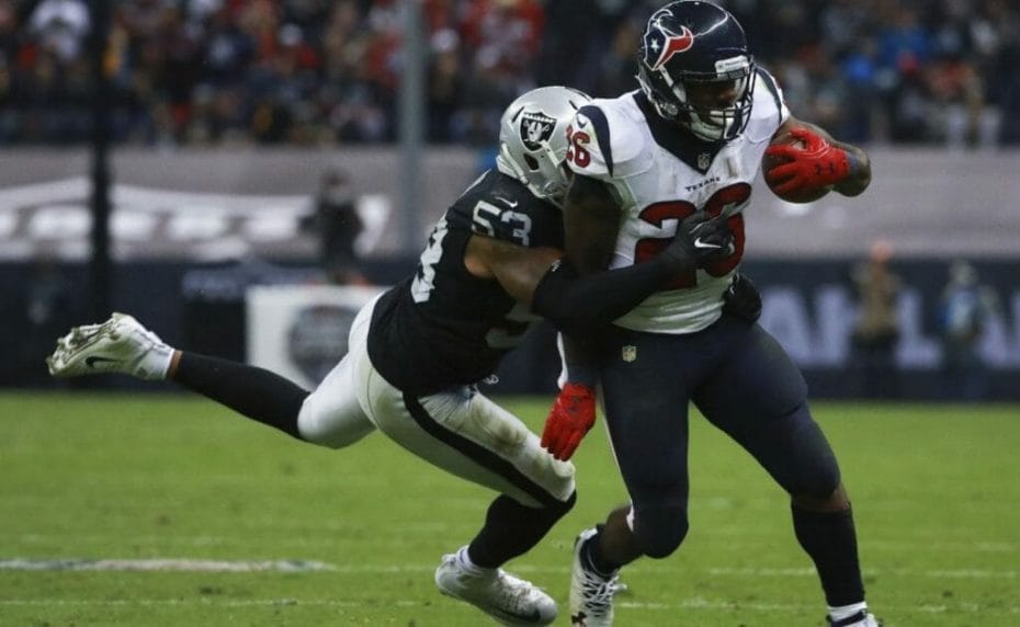 Houston Texans vs Oakland Raiders, player with ball tackled by opponent
