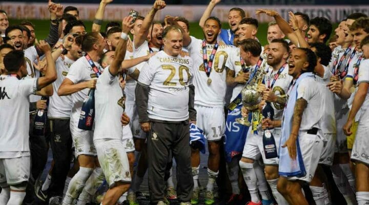 Leeds players celebrate manager Marcelo Bielsa with the trophy during the Sky Bet Championship July 2020. Photo by Michael Regan/Getty Images