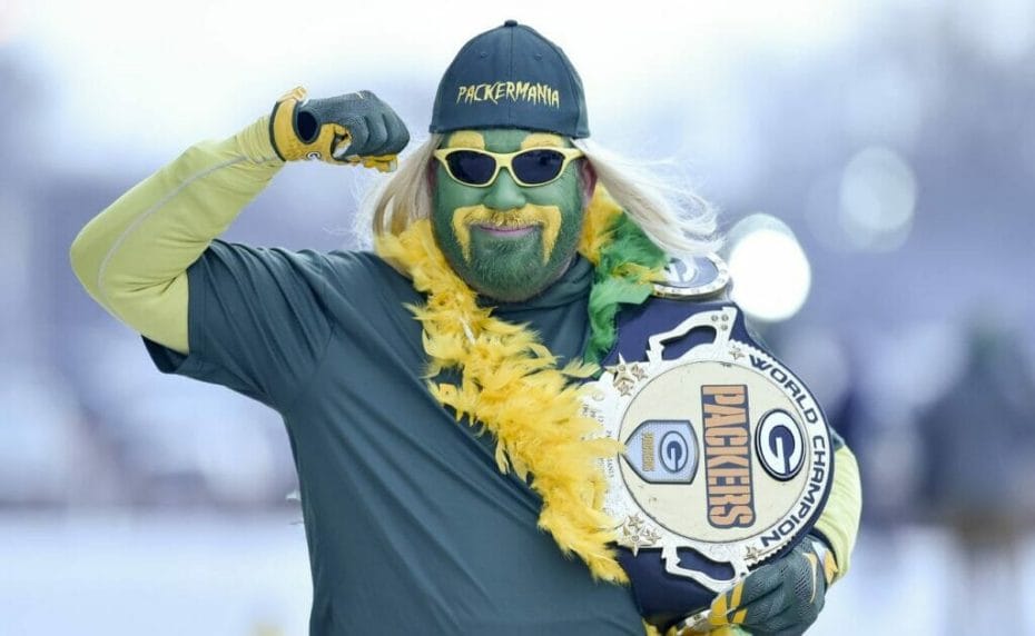 A fan of the Green Bay Packers flexes his right arm while carrying a Green Bay Packers belt in his left. Photo by Quinn Harris/Getty Images.