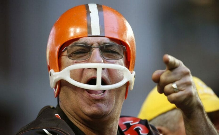 : A Cleveland Browns fan wears a helmet and points his finger towards the camera. Photo by Ralph Freso/Getty Images.