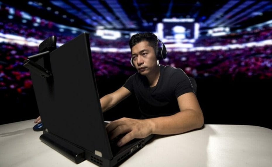 Professional eSports video gamer playing an FPS or MMO game on a computer and streaming online.