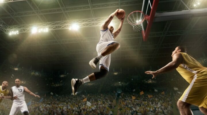 An NBA player goes for a slam dunk.