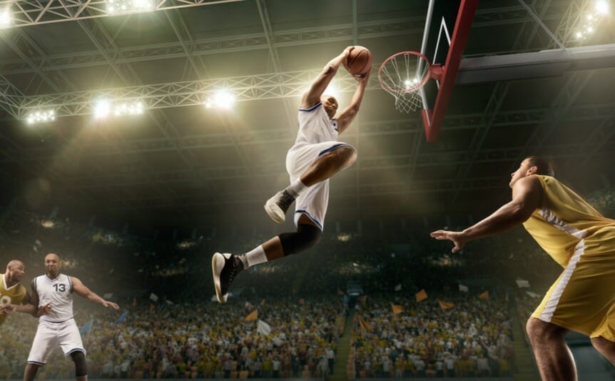 An NBA player goes for a slam dunk.