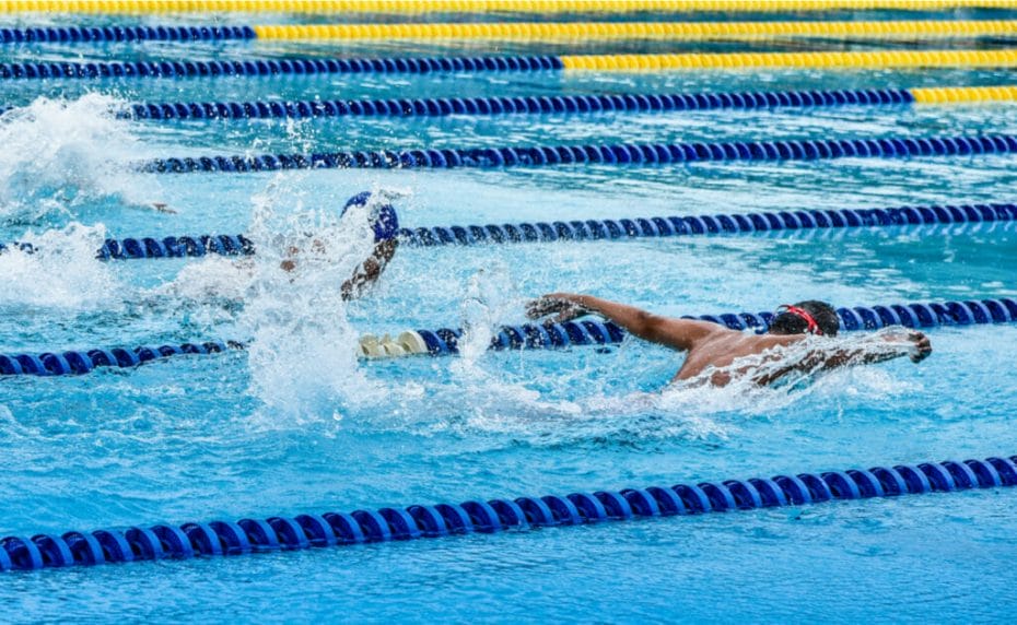 Male competitive swimmers competing in a butterfly race.