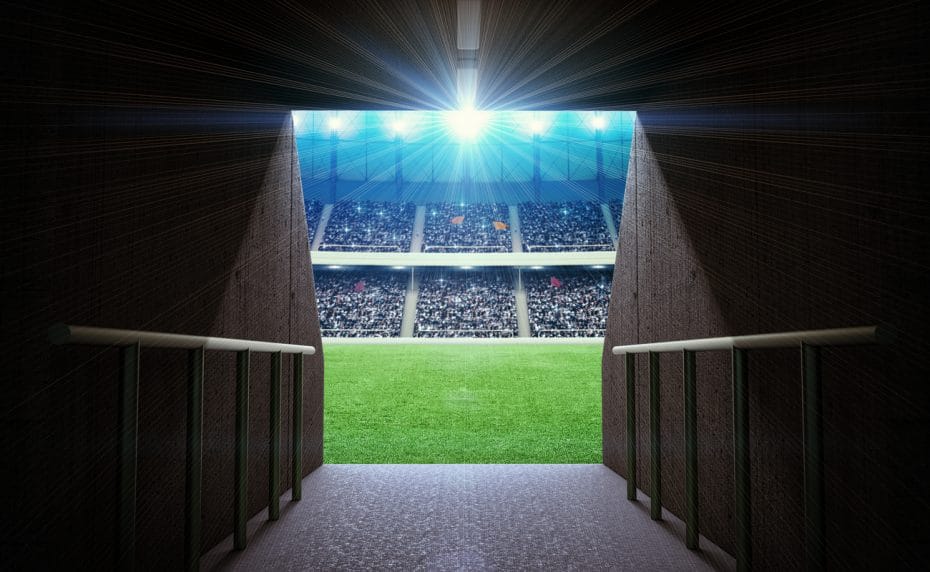 The tunnel leading out onto a soccer pitch.