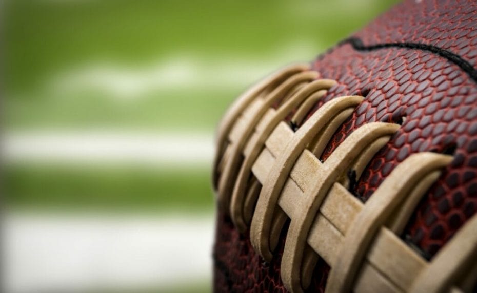  Closeup of a vintage worn american football ball with visible laces, stitches and pigskin pattern