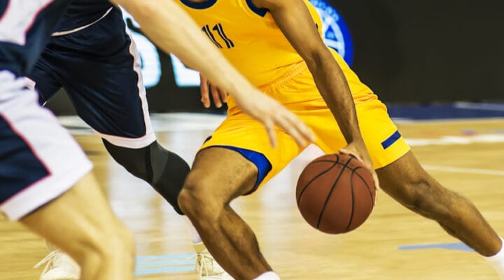 A player with a basketball dribbles the ball.