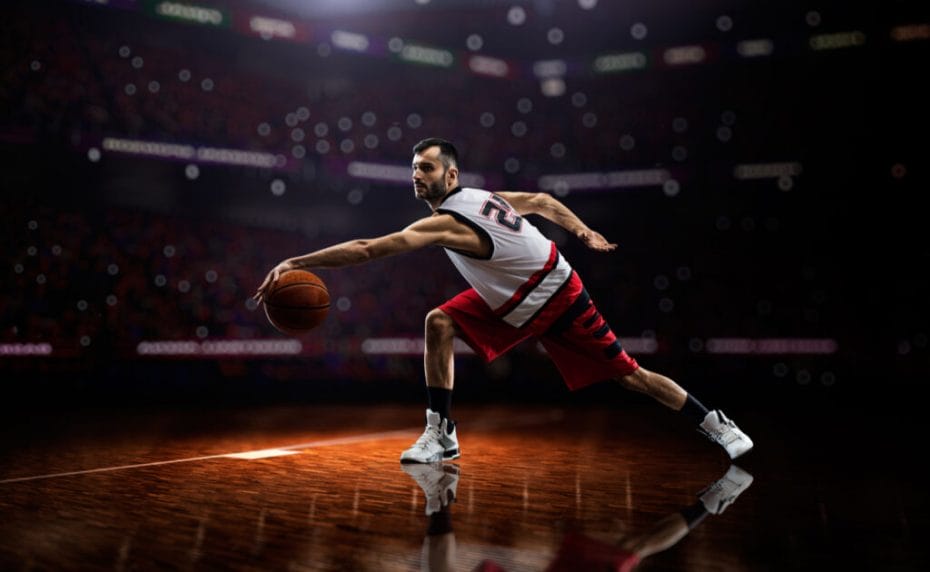 A basketball player dribbling the ball on the court.