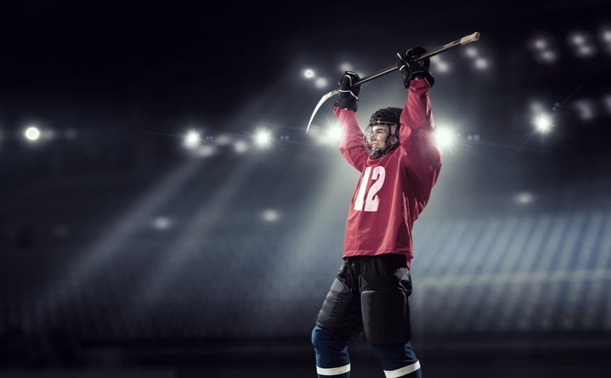 An ice hockey player celebrates a win.