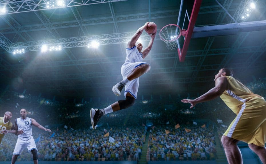 A professional basketball player leaps into the air to shoot a hoop.