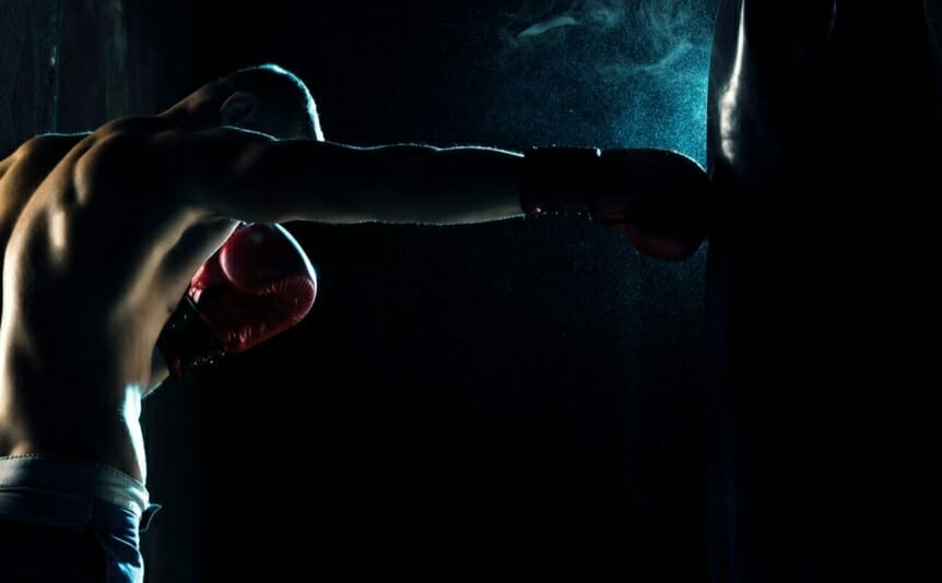 A man boxing a bag.