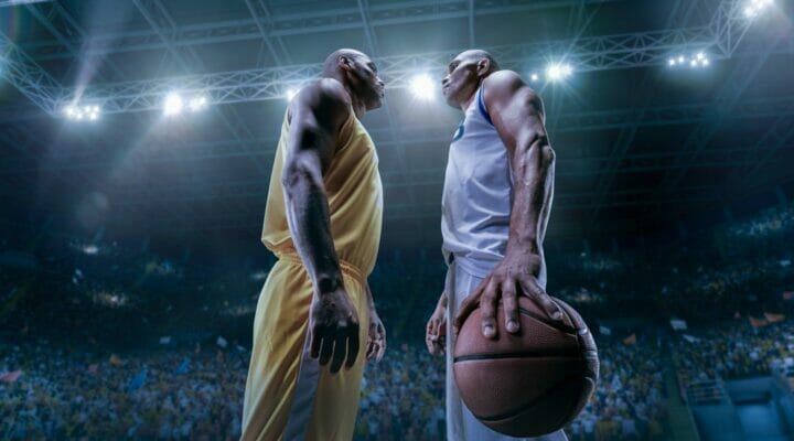 Two African American basketball players face off against each other.