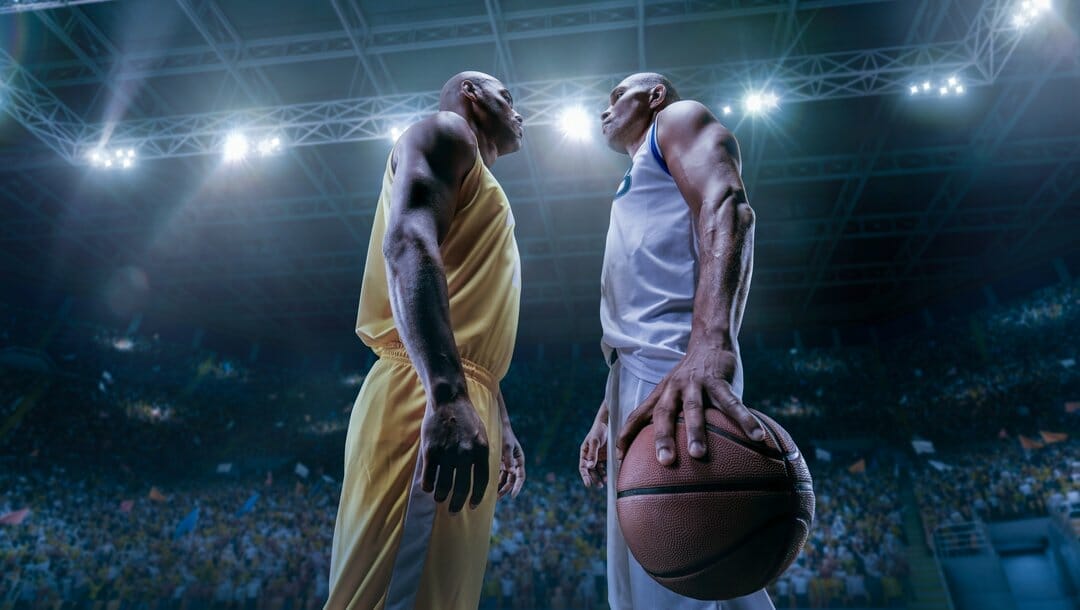 Two African American basketball players face off against each other.