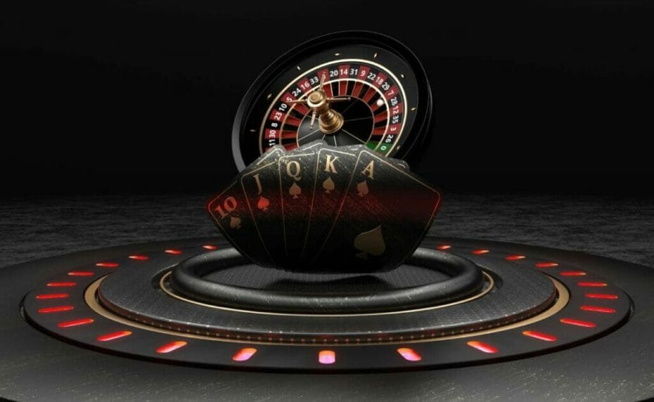 A black and red roulette wheel and playing cards.