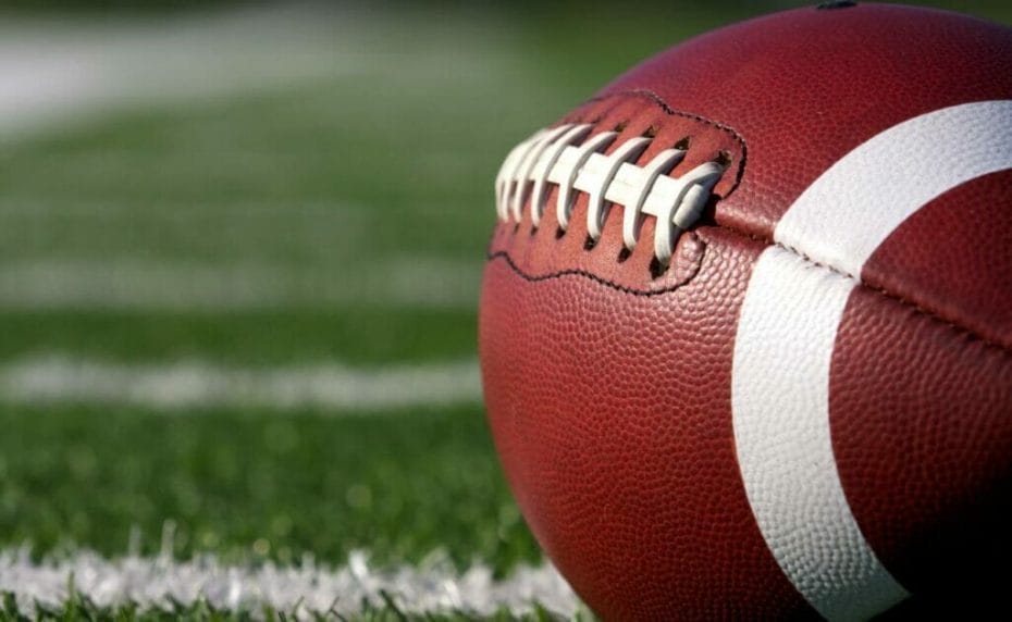 Close-up of an American football on the field.