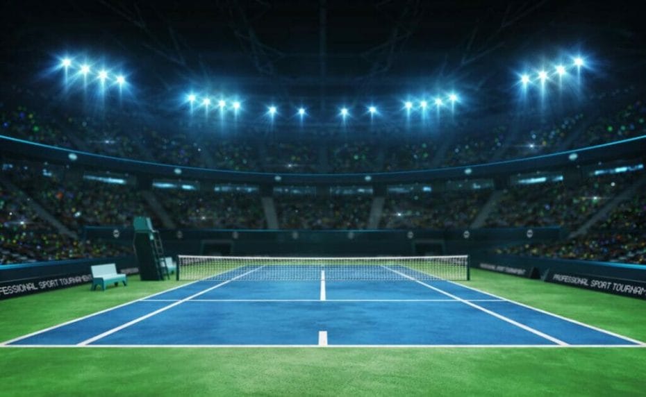 A blue tennis court with indoor lights in the background.