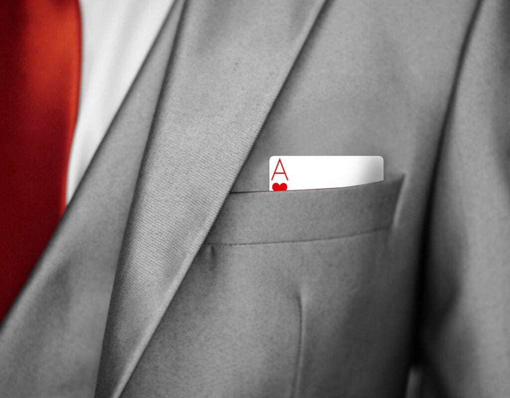 An ace card sticking out a business jacket pocket.