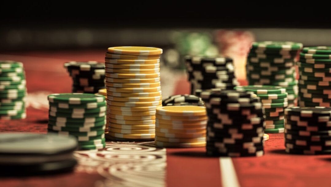 Close-up view of stacks of poker chips on a poker table.