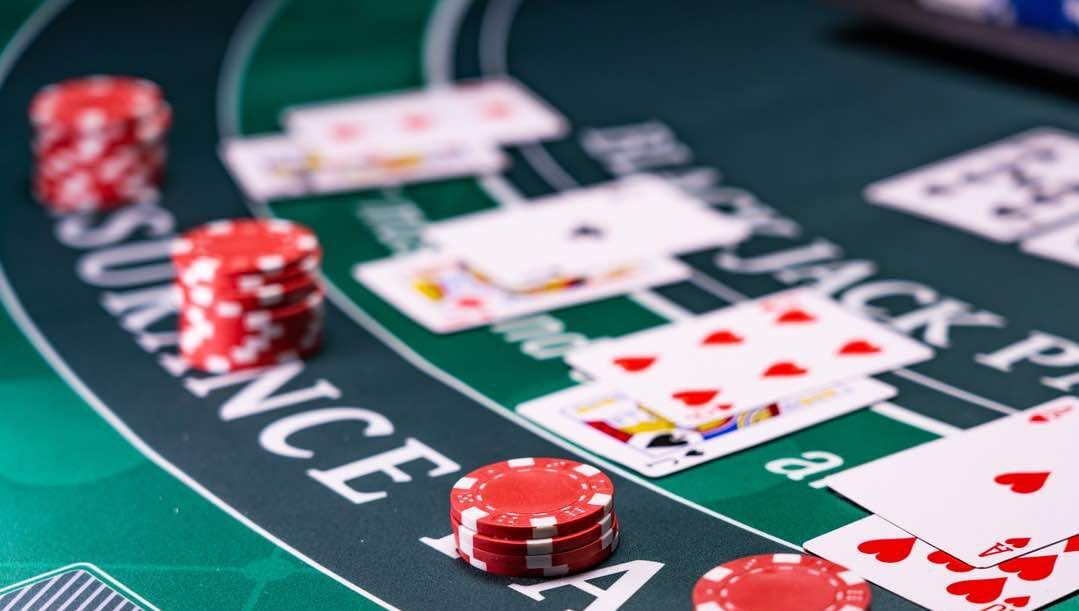 A blackjack casino table with cards and chips.