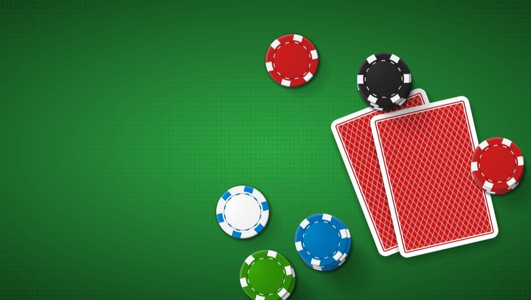 Poker chips and cards lying face-down on a casino table.